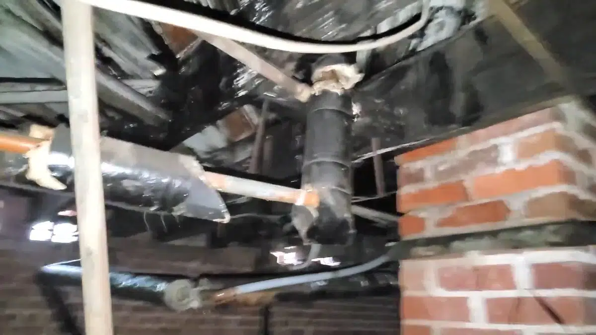 Crawlspace drain piping and repair access below a home for Plumbing Near John Anson Ford Park, Bellflower CA