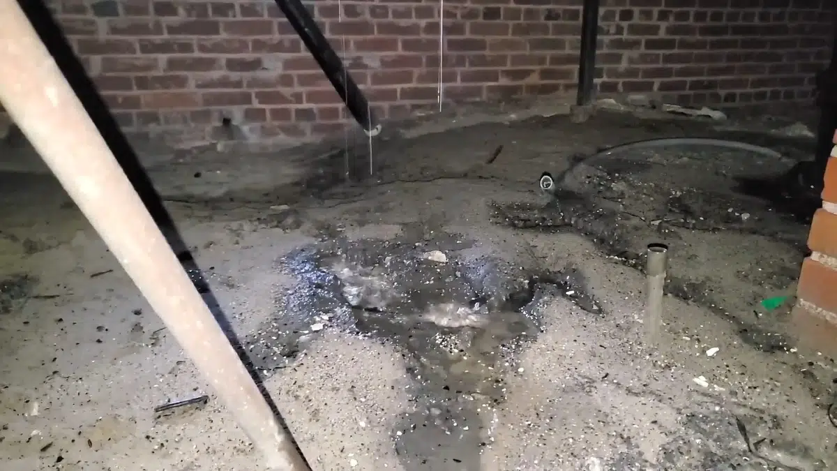 Crawlspace drain piping and repair access below a home for Plumbing Services in Lynwood, CA