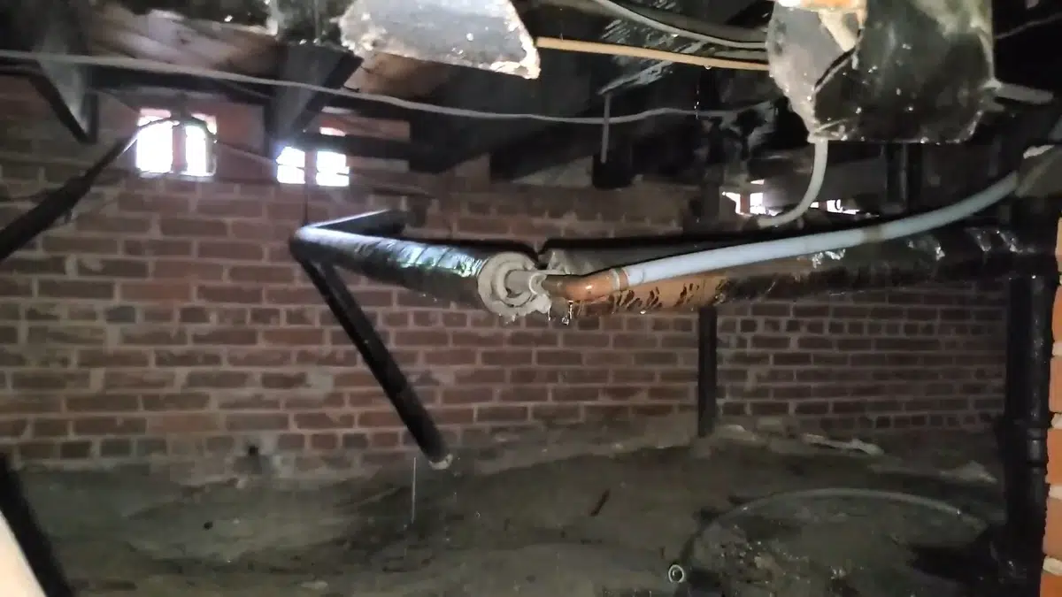 Crawlspace drain piping and repair access below a home for Plumbing Services in Long Beach, CA