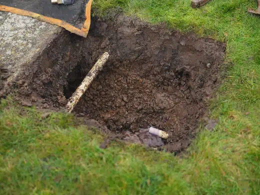 Open trench with sewer or water line replacement pipe exposed for Plumbing Service Areas in Index.Html detail view