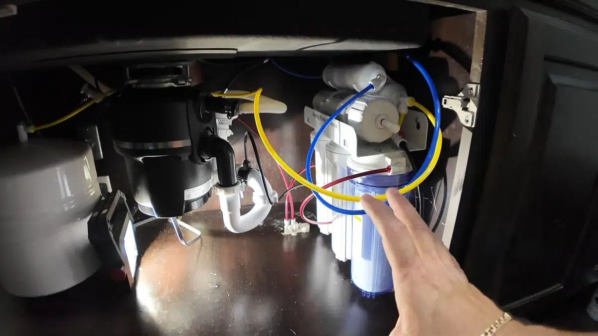 Under-sink water filtration system connected below a kitchen sink for Water Filtration Installation in Bellflower, CA