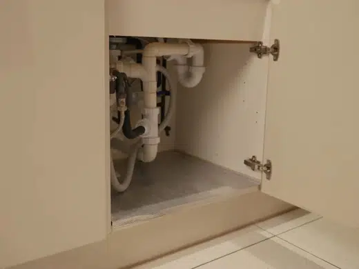 Under-sink water filtration system connected below a kitchen sink for Plumbing Services in Bellflower, CA