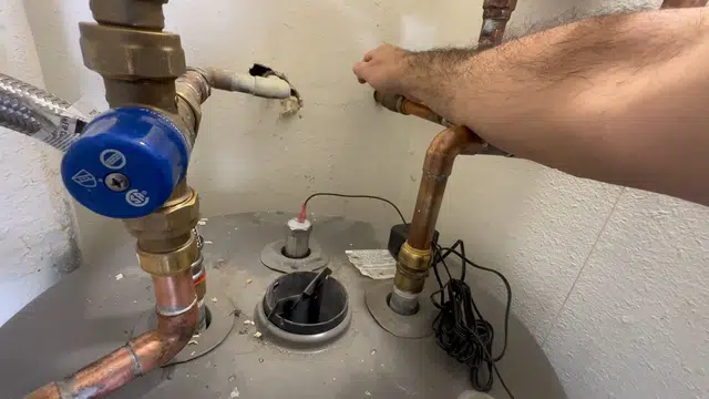 Water heater component showing corrosion, anode wear, or inlet repair for Plumbing Tips and Guides